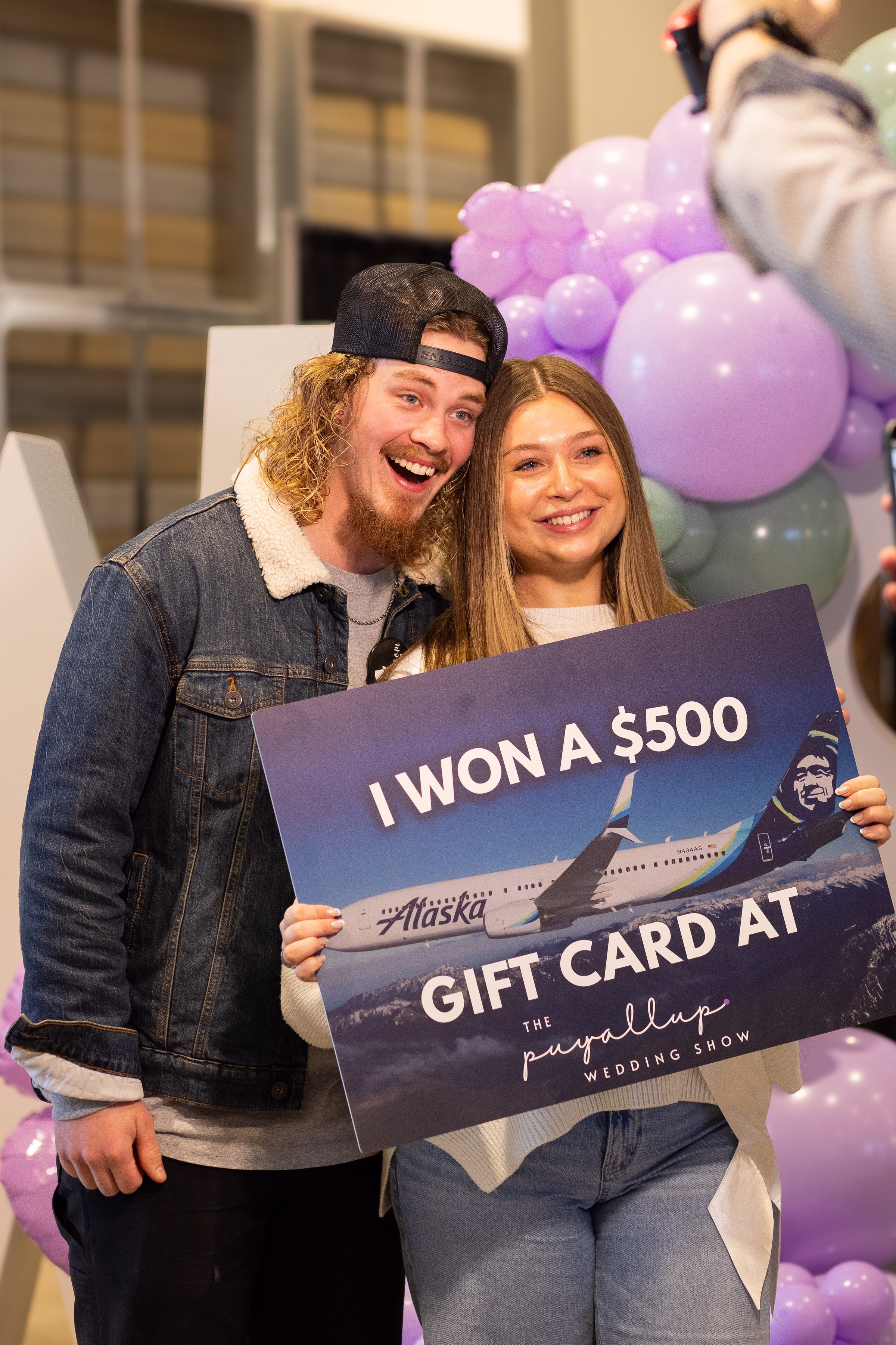 alaska airlines gift card winner puyallup wedding show - The Puyallup Wedding Show Excited couple holds a sign announcing they won a $500 Alaska Airlines gift card at The Puyallup Wedding Show in Puyallup Washington