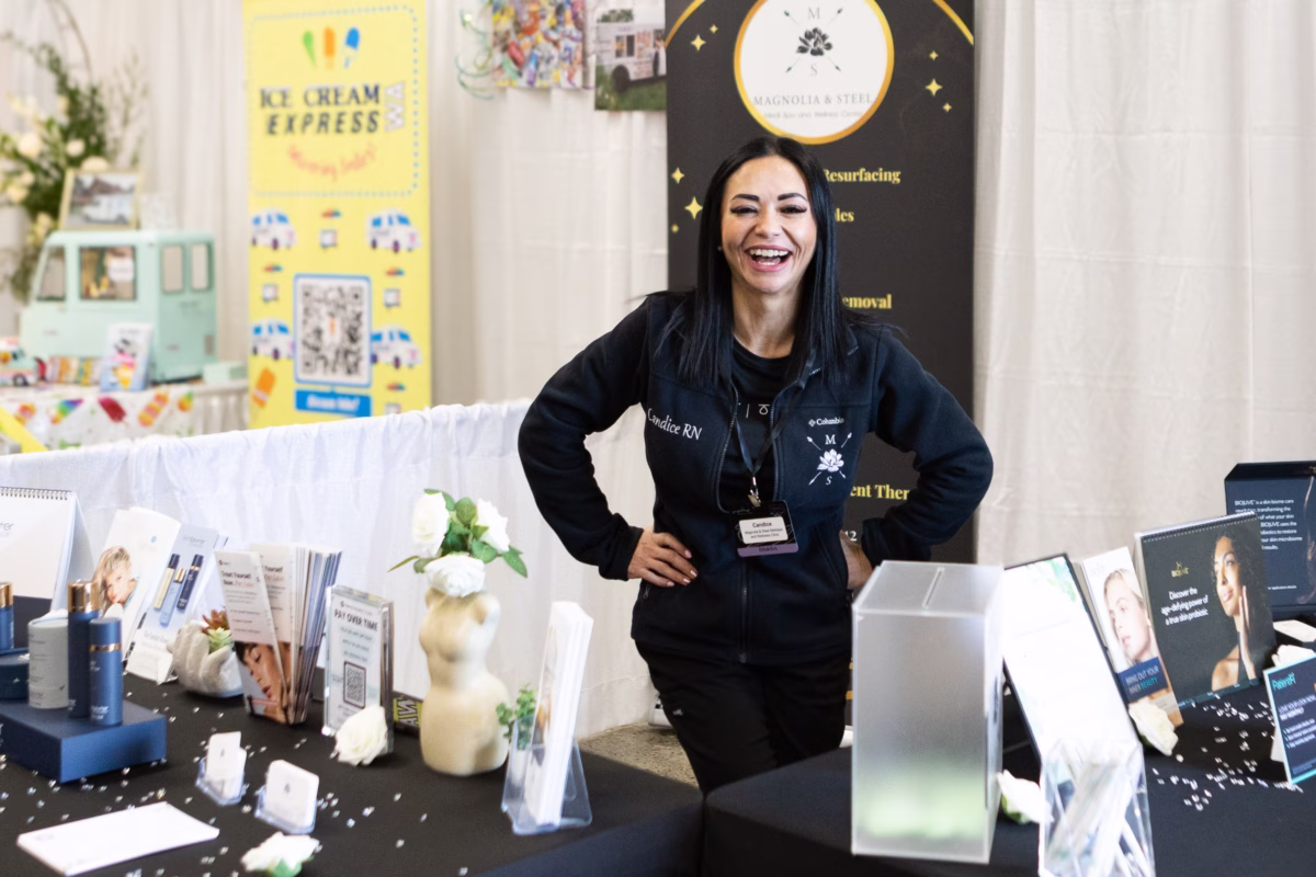 magnolia and steel skin wellness vendor booth puyallup - Exhibiting Information Candice RN smiles at her Magnolia and Steel skin care and wellness booth at the Puyallup Wedding Show in Puyallup Washington