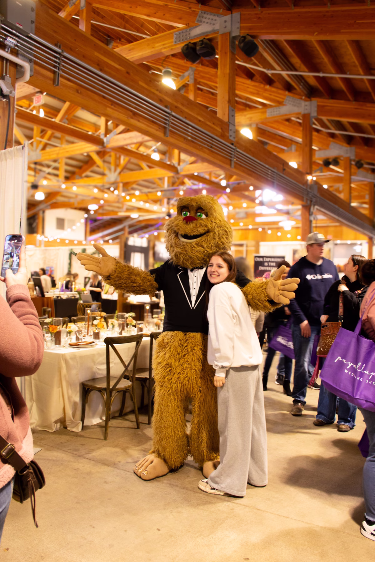 puyallup wedding show sasquatch mascot bridal expo - Upcoming Shows A smiling attendee poses with the Sasquatch mascot in a tuxedo at the Puyallup Wedding Show bridal expo in Puyallup Washington