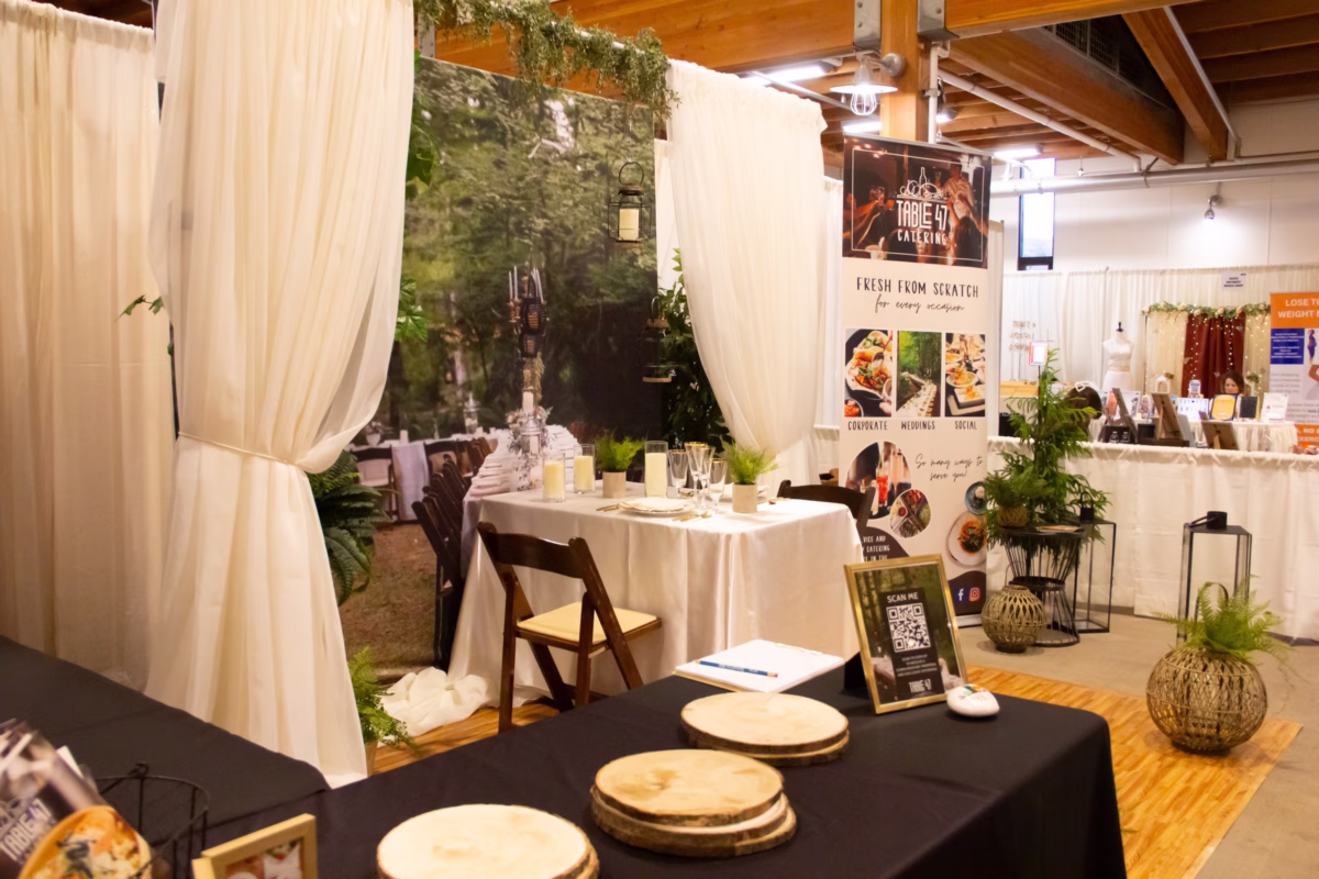table 47 catering booth puyallup wedding show - February 2027 Table 47 Catering wedding expo booth displaying elegant table settings and fresh-from-scratch catering services at the Puyallup Wedding Show in Puyallup Washington
